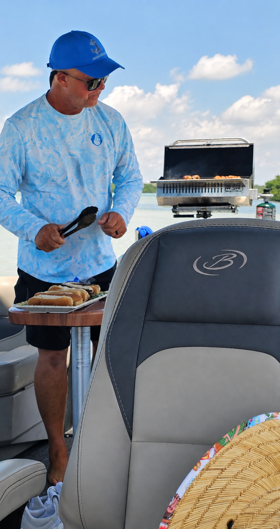 Captain John grilling lunch on the boat's onboard Magma grill while anchored near a mangrove shoreline